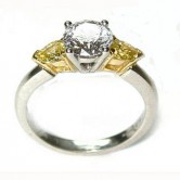 18ct gold ring set with a round brilliant cut diamond and 2 natural fancy yellow pear cut diamonds